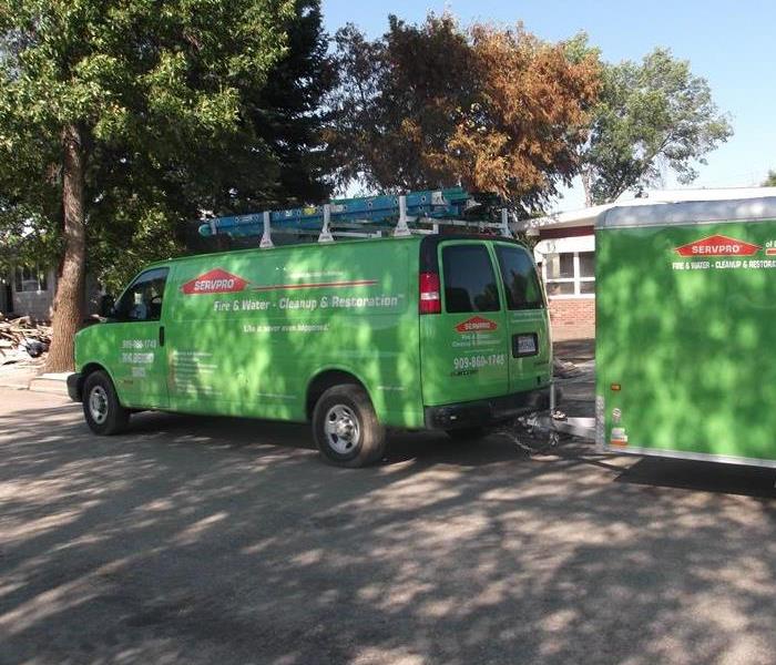 SERVPRO van parked outside house.