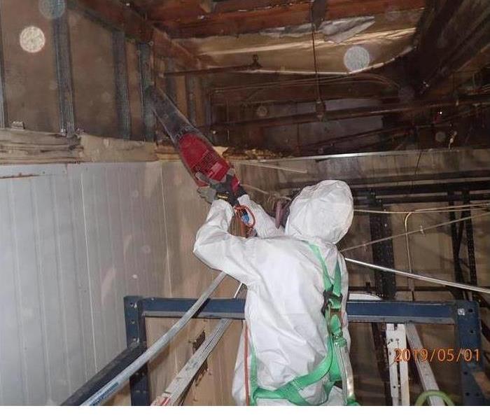 man in suit cleaning a property